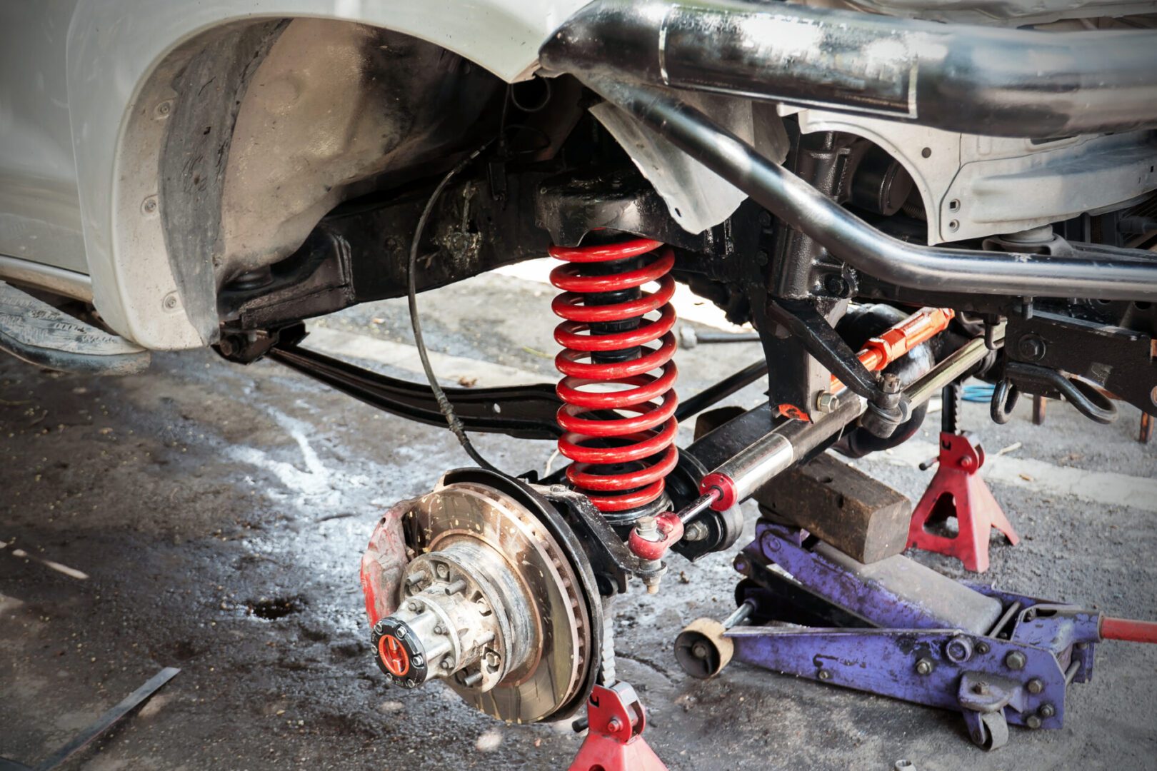 Close-up of car's exposed suspension components
