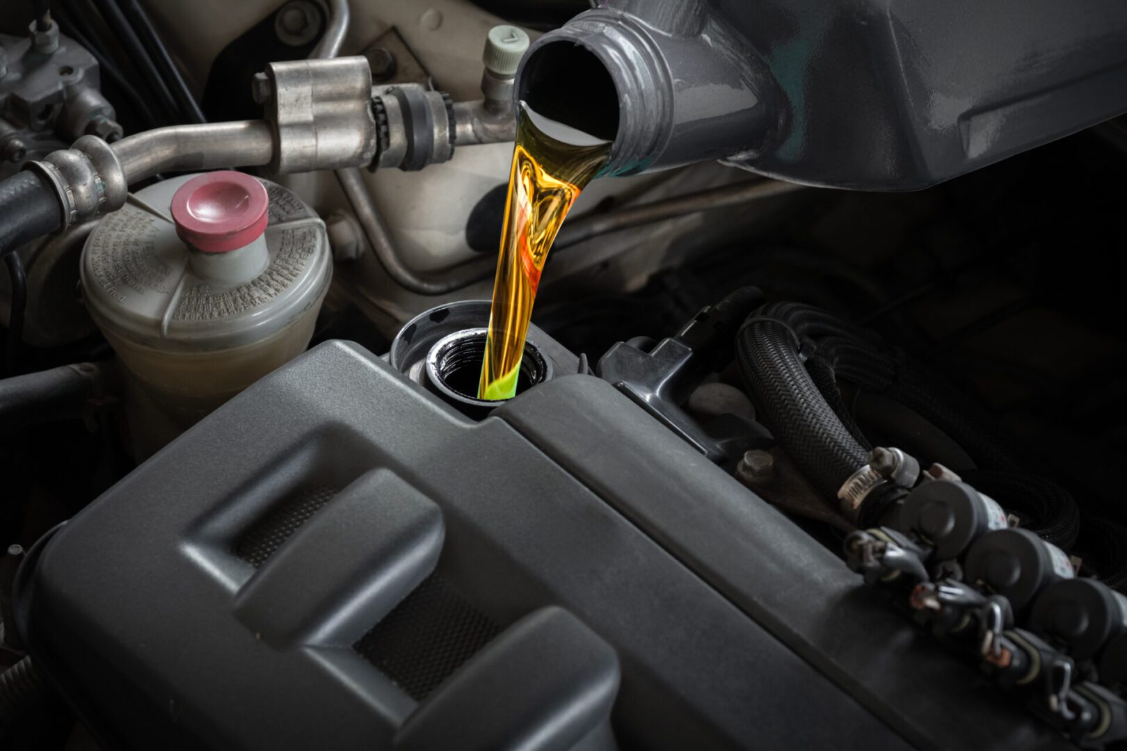 Pouring engine oil into car