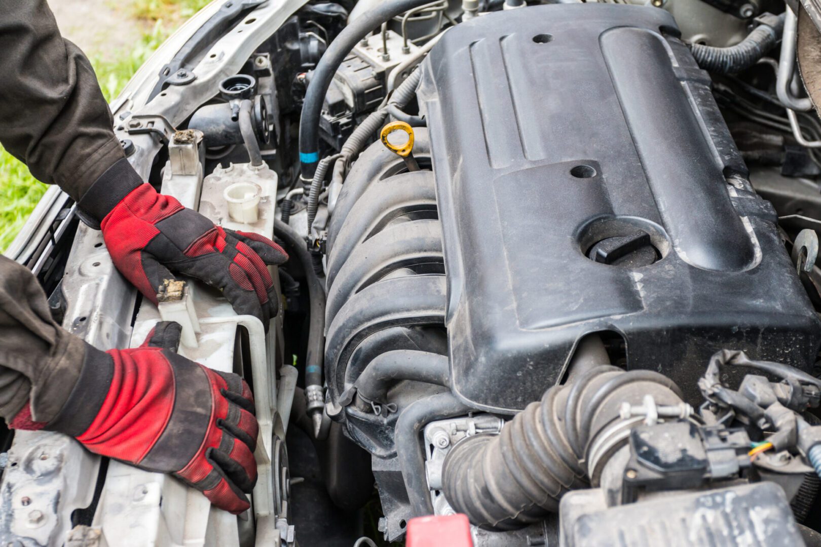 Hands repairing car engine