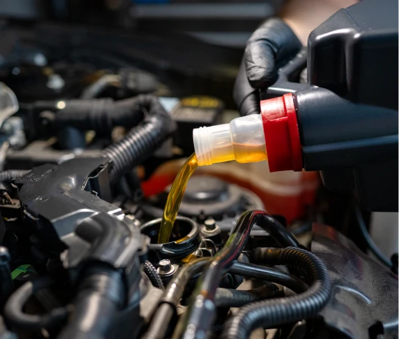 Pouring engine oil into car